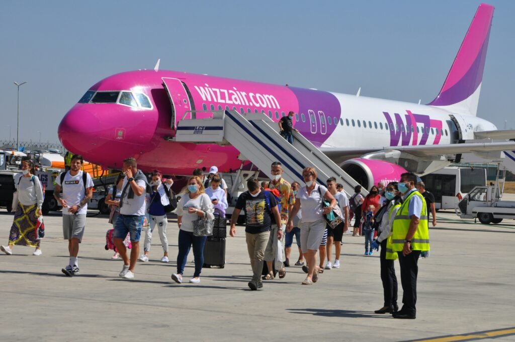 Wizz Air aircraft and passengers on the tarmac at a European airport