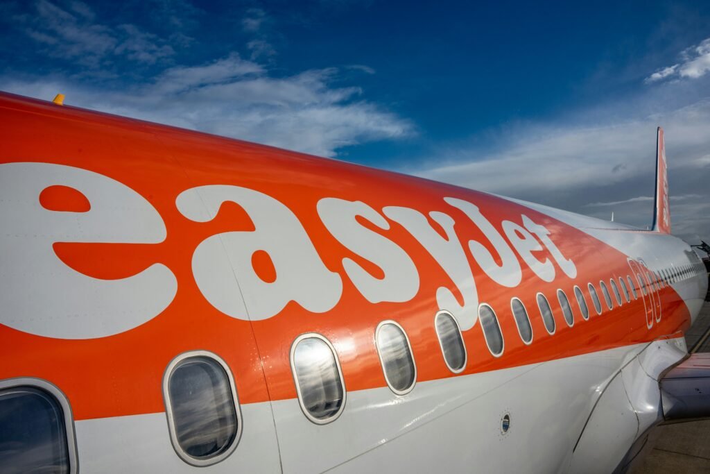The easyJet logo painted on the orange and white fuselage of an Airbus A320 family aircraft
