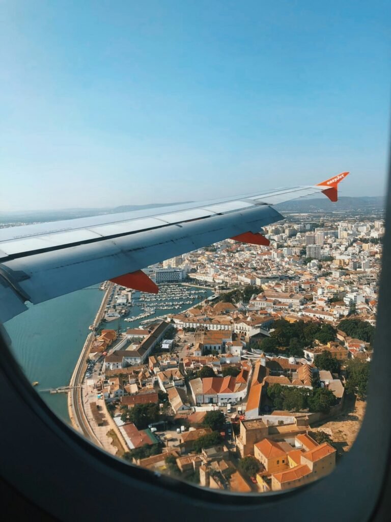 View from an easyJet window of the wing over Faro, with its marina and old town in the Algarve