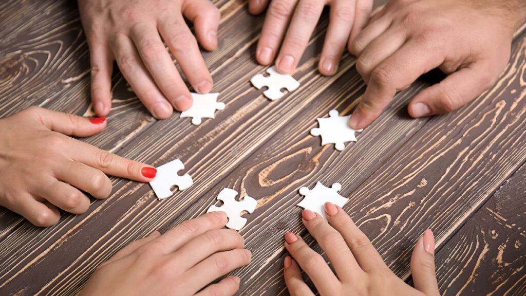 Candidates' hands working together on a jigsaw puzzle, like the group exercise at the Jet2 cabin crew assessment day
